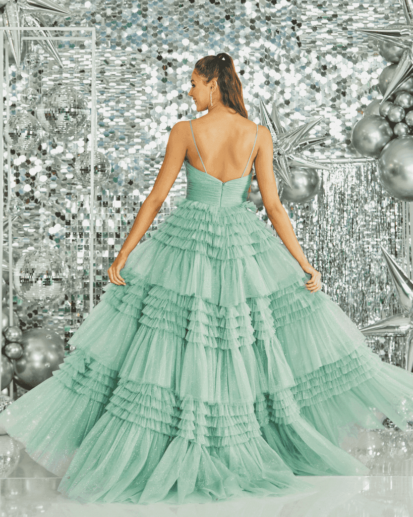 Back view of Tiffanys Prom - Tiered Ballgown in mint green with voluminous ruffled layers and shimmering tulle design.
