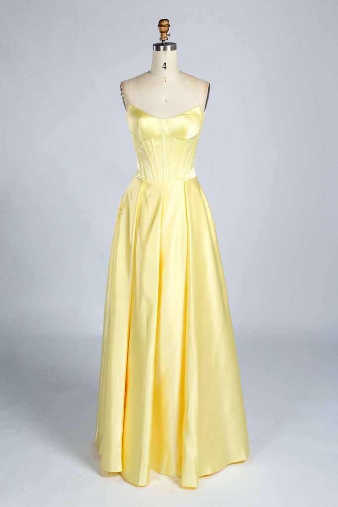 Front view of light yellow Jessica Stuart Darcet Prom Gown with strapless corset bodice and full-length satin skirt.