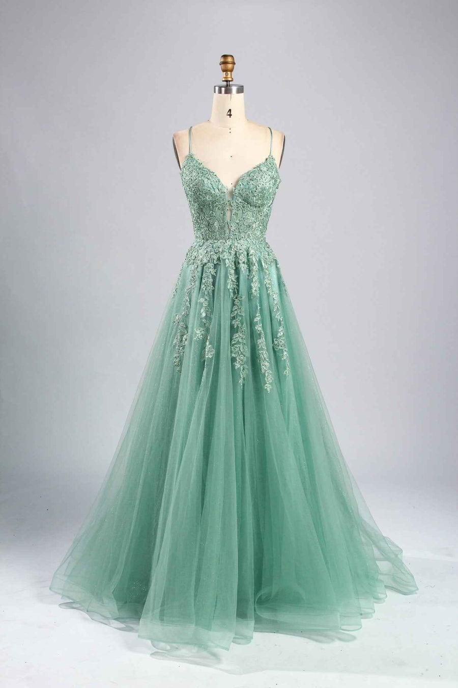 Joy Sage Green Floral Applique Tulle Ballgown by Jessica Stuart with a deep V-neckline, floral embroidery, and flowing tulle skirt. Ideal for prom or gala events.