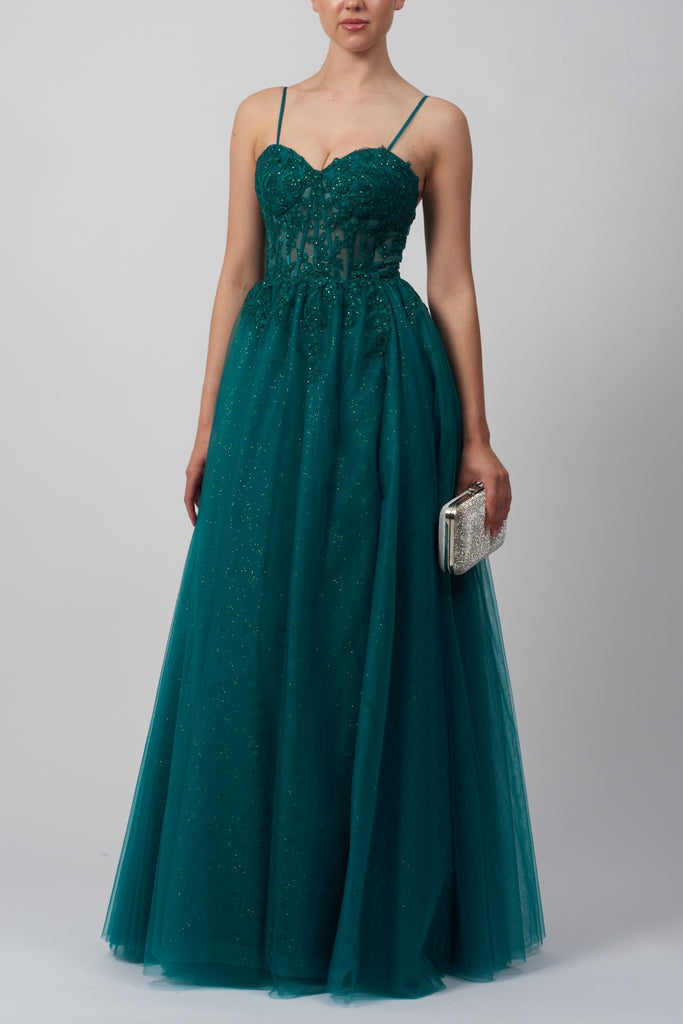 model standing in a green sparkle prom dress