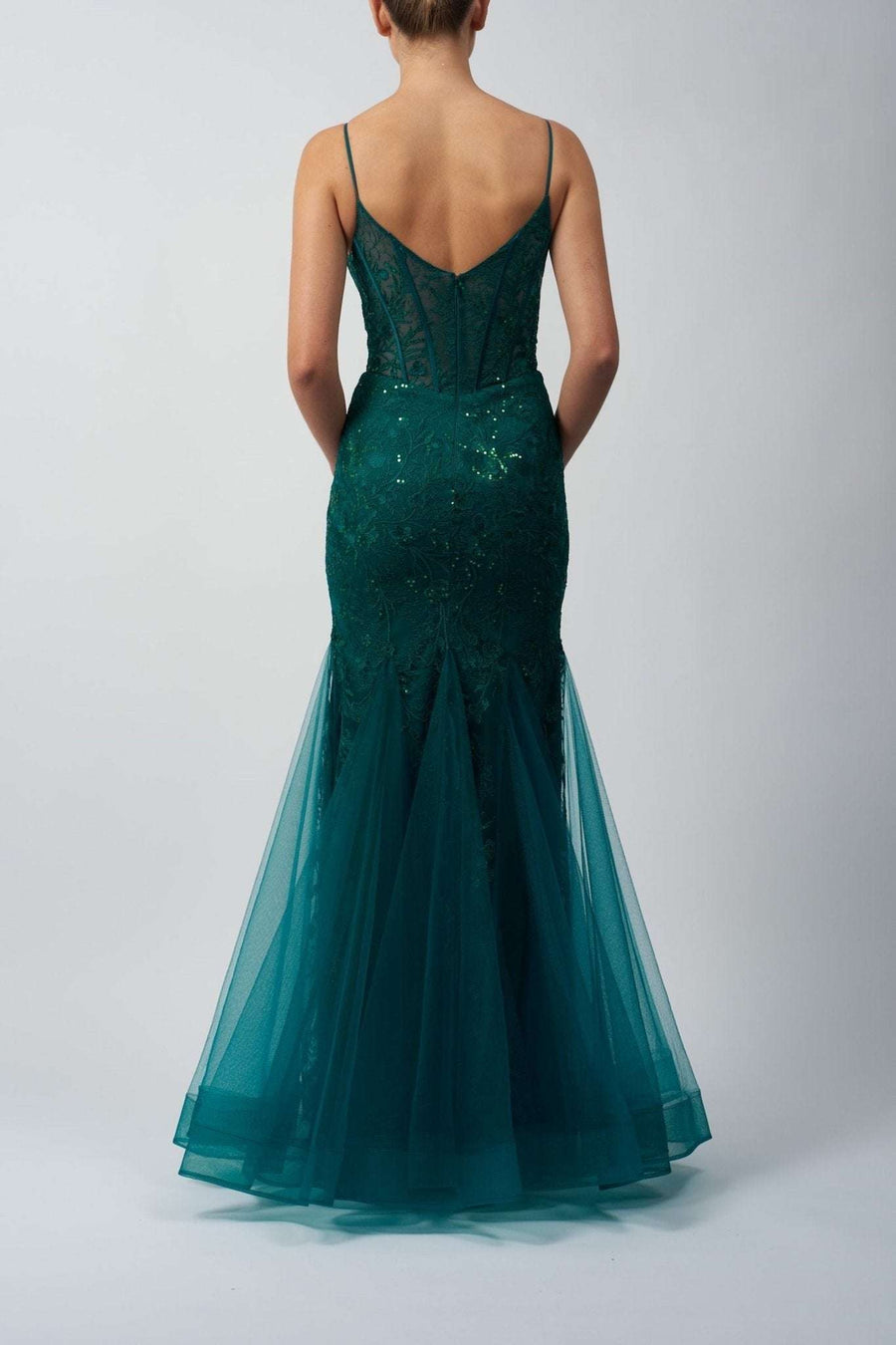 back view of a model in a green mermaid lace dress 