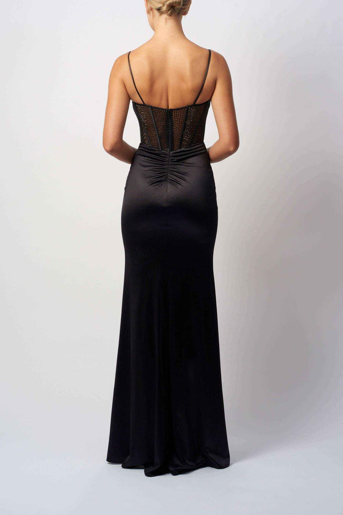 Back view of Mascara MC11434 HOT FIX Jersey black corset long satin gown showing mesh paneling and ruched detailing for a sleek silhouette.