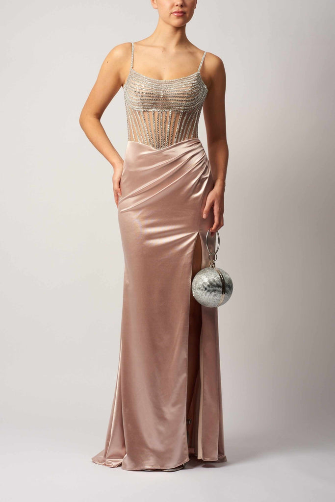 MC11445 Mascara Gown in champagne shiny jersey with beaded bodice, thigh-high slit, and ruched waist. Ideal for prom or formal events.