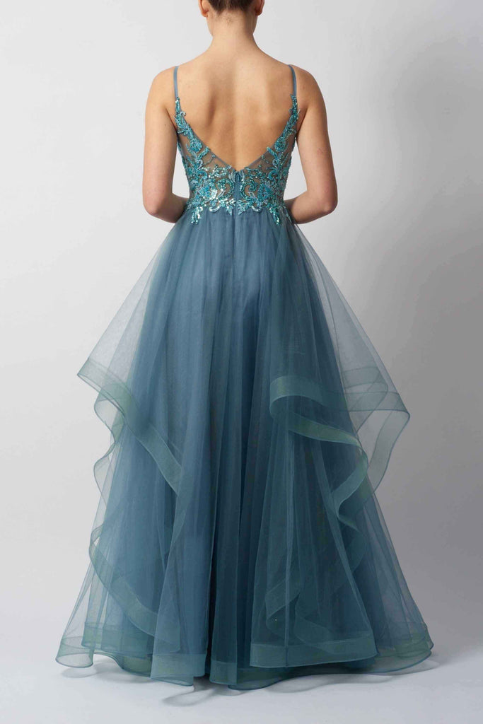 Back view of navy tulle ball gown prom dress with deep V-back, floral embellishments, and cascading layered skirt for red carpet-ready elegance.