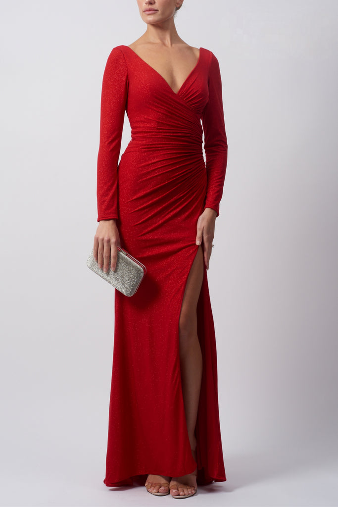 lady standing forward in a long-sleeved red glitter rouched evening gown