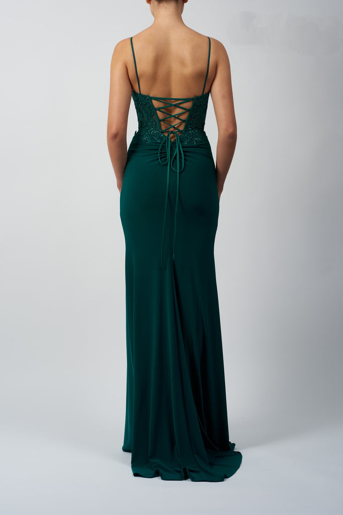back view of model in green fitted corset dress