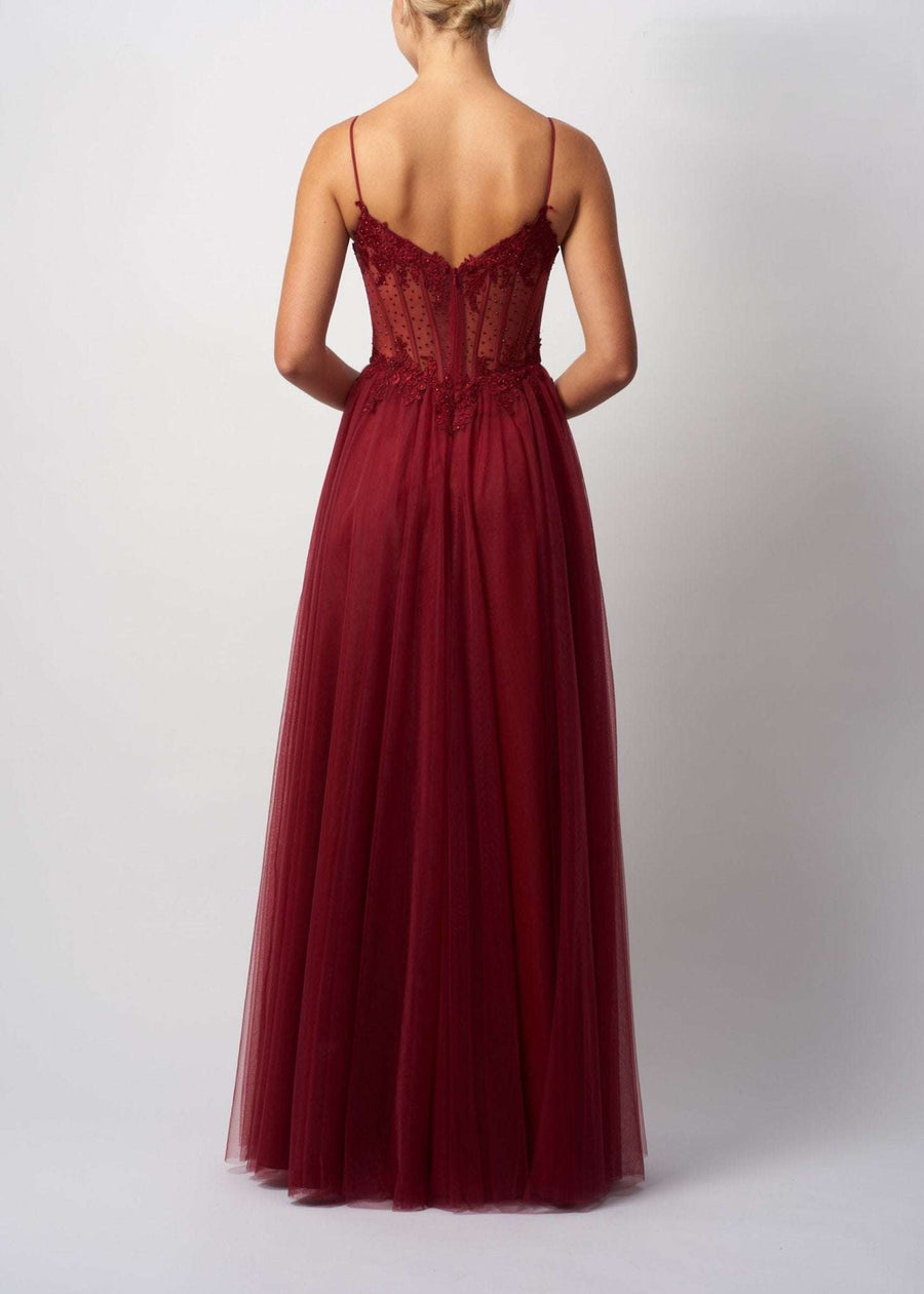 Back view of Mascara London MC18441 Wine Tulle Ballgown featuring a sheer embellished corset bodice and flowing tulle skirt. Ideal for prom 2025.