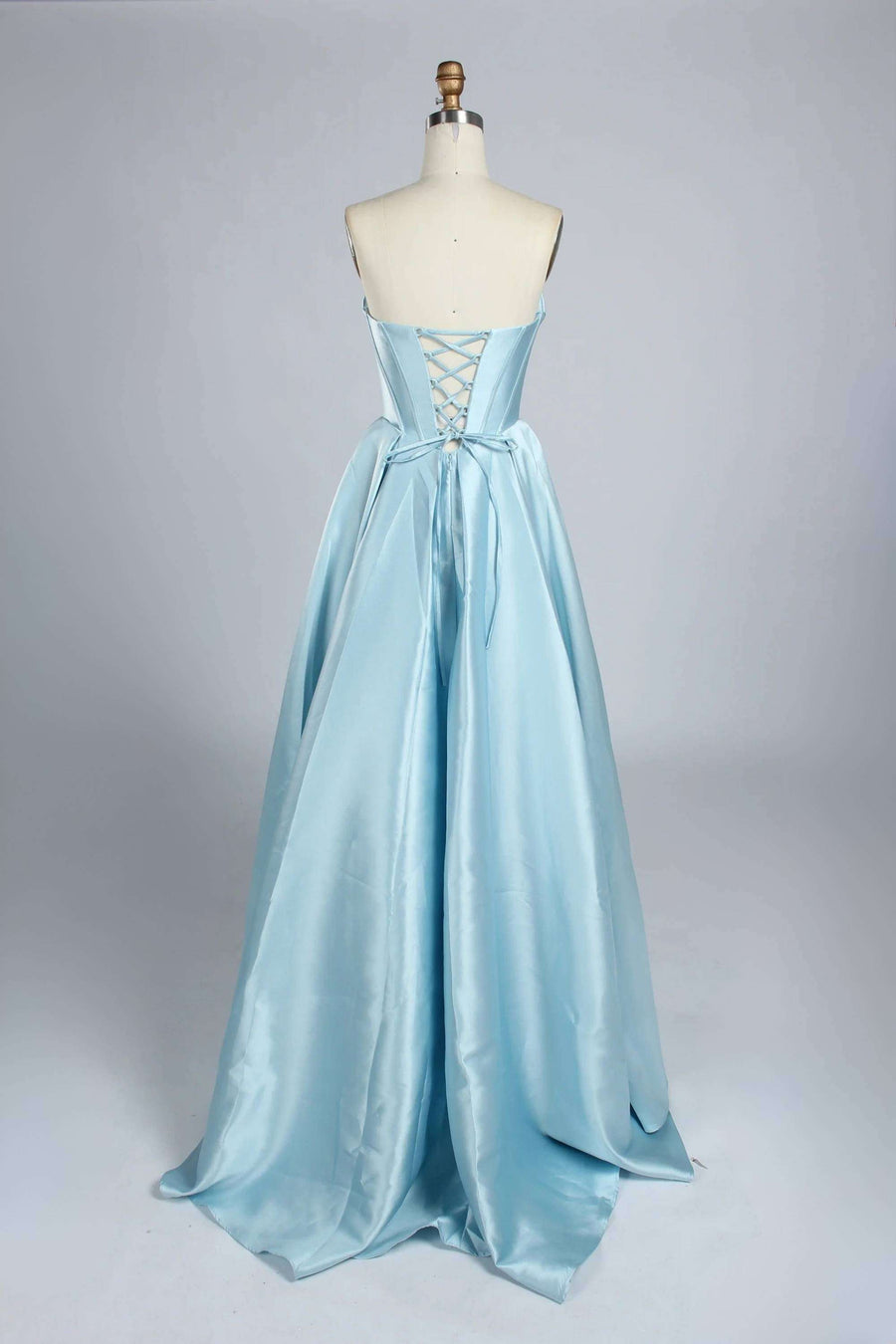 Back view of Jessica Stuart Light Blue Satin Phoebe Prom Gown featuring lace-up corset and full-length satin skirt.
