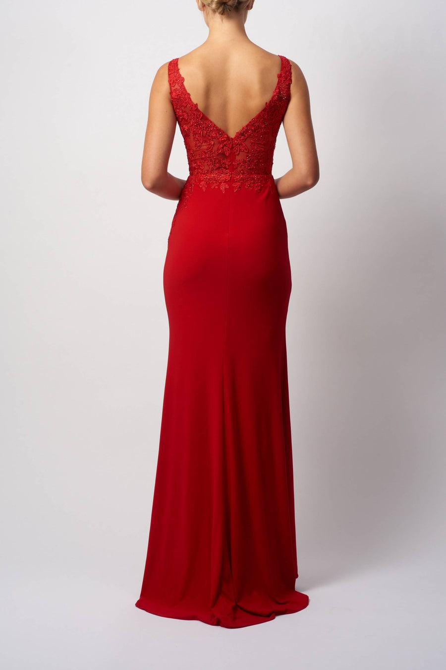 Red evening gown with lace detailing on a white background