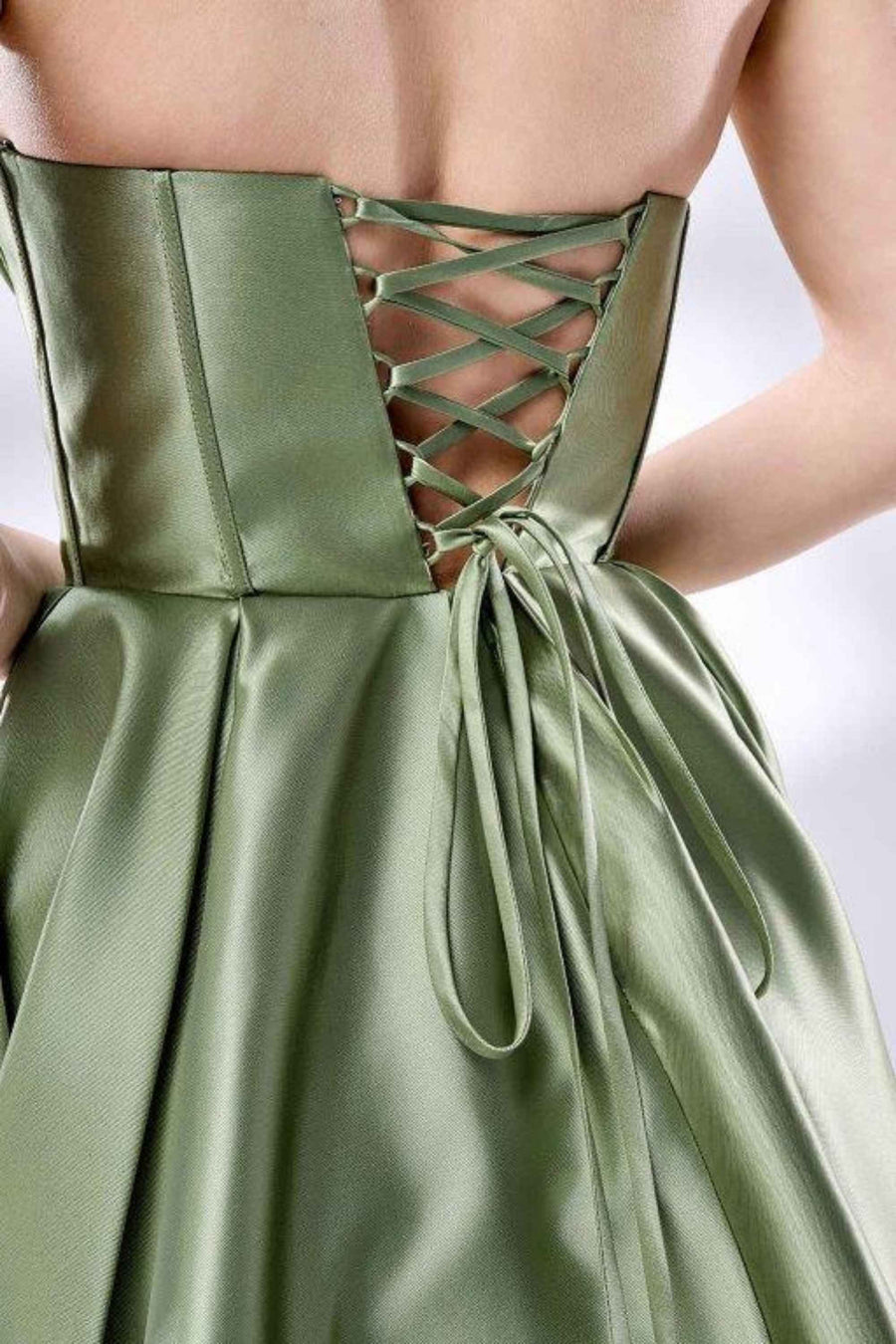 Close-up of green satin ballgown’s lace-up corset back, showcasing detailed stitching and structured bodice for a secure, elegant fit.