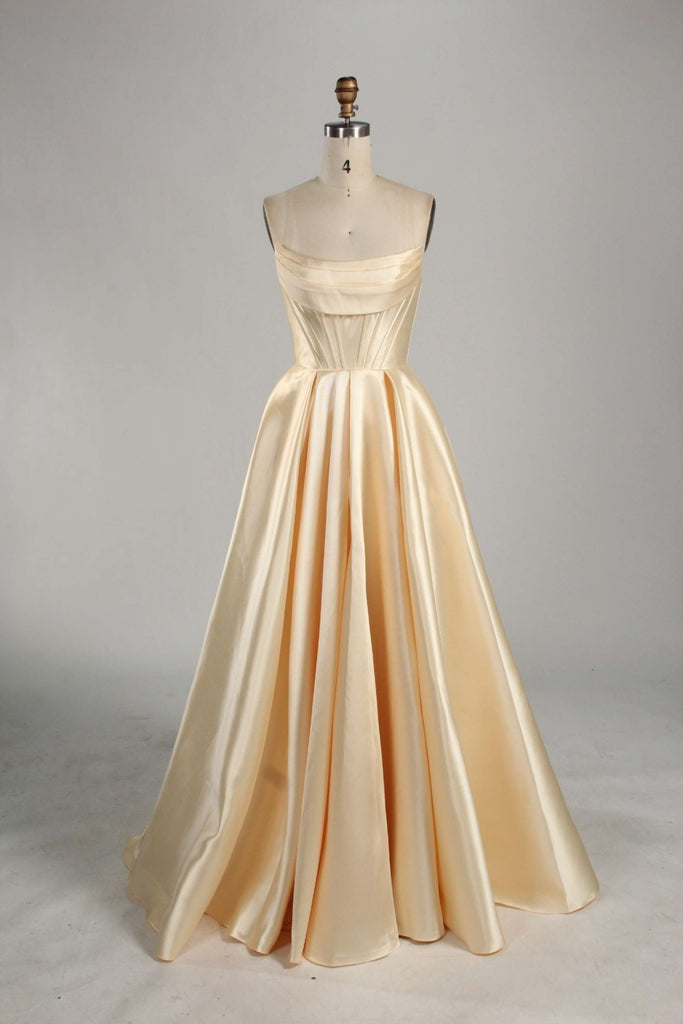 Jessica Stuart yellow satin ball gown with pockets, featuring a strapless bodice and full-length flowing skirt. Ideal for prom or elegant events.