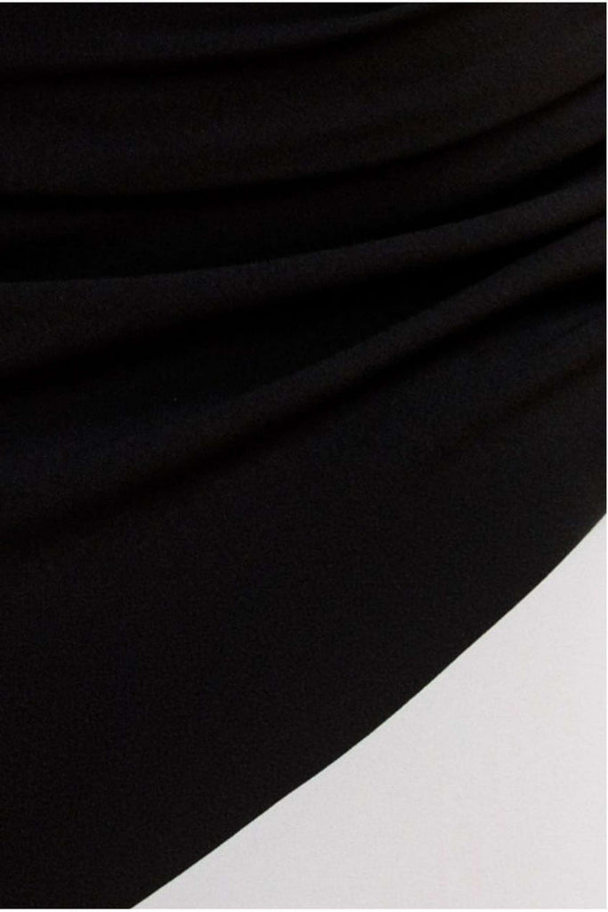 Close-up of Goddiva Maxi Dress in black cream, showcasing ruched detailing and smooth fabric texture on the mermaid hem silhouette.