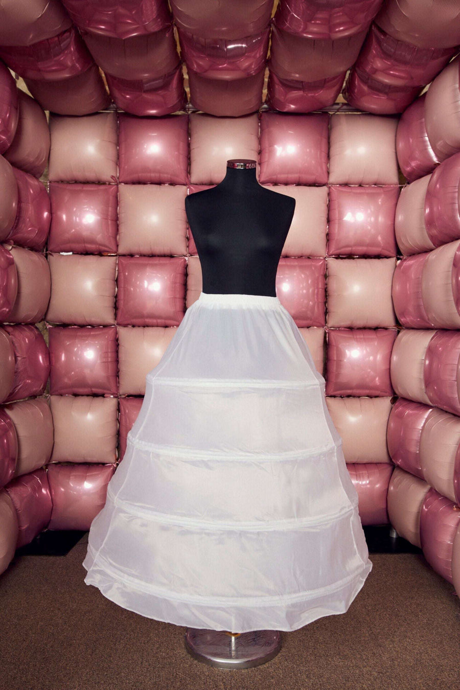 Tiffany's Net Hoop Underskirt for Dresses displayed on mannequin, featuring layered white mesh for volume under bridal gowns or formal skirts.