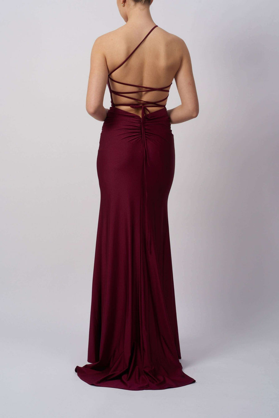 Back view of Tie Back Dress MC12333 in petrol by Mascara, featuring a single strap open back and ruched detailing. Elegant long gown for prom or parties.