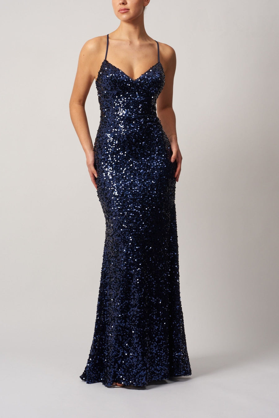 MC11345 Tie Back Gown in navy features full-length sequin detailing and a fitted silhouette, ideal for prom or red carpet events.