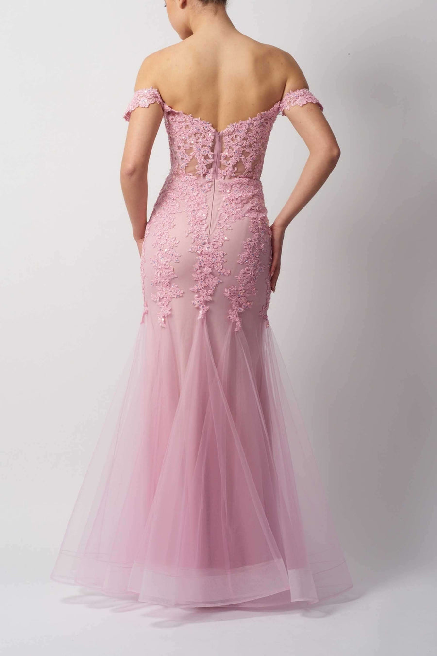 Back view of Mascara London's Blue Fishtail Gown MC115110 in pink, featuring embroidered lace, off-shoulder sleeves, and tulle mermaid skirt.