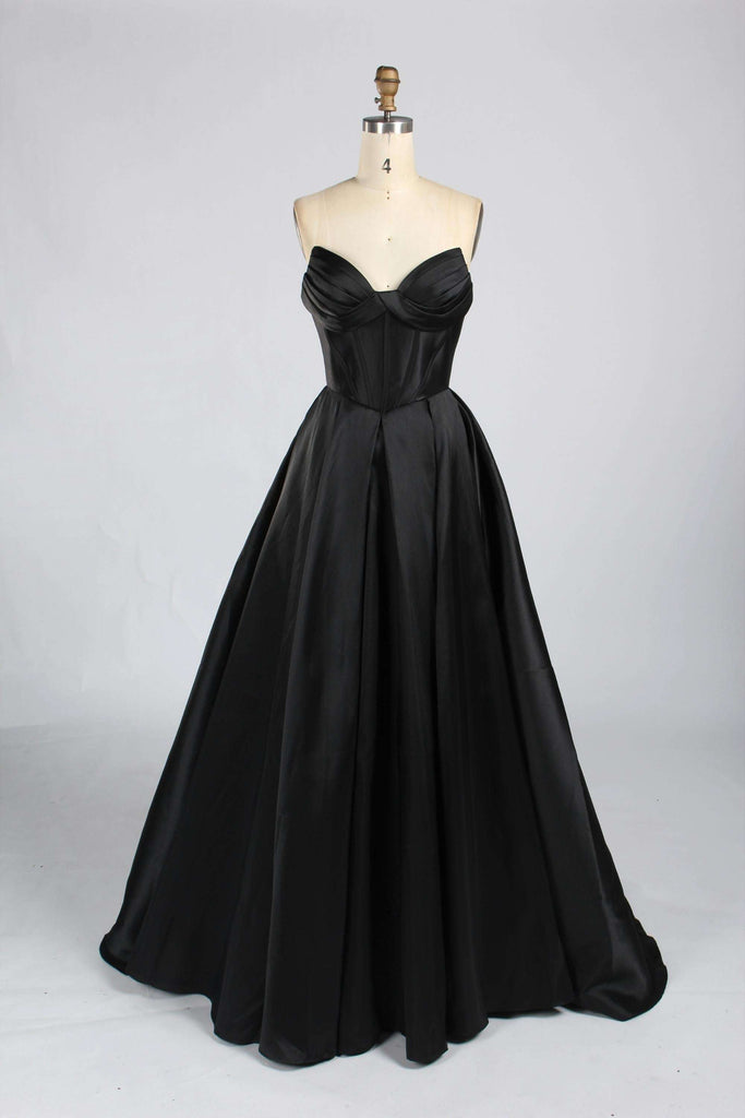 Black satin strapless prom gown by Jessica Stuart 33313B featuring a sweetheart neckline, ruched bodice, and full-length ballgown skirt.