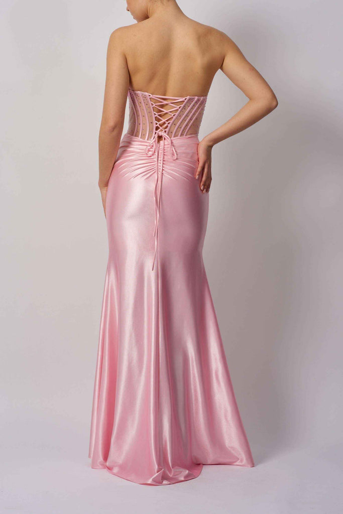 Back view of Mascara MC113423 pink beaded bust gown featuring lace-up corset detail and flowing satin mermaid skirt.