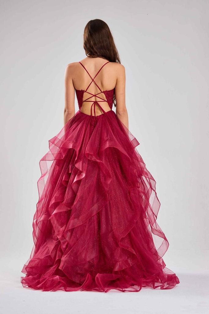 Back view of Jessica Stuart Ruby Ruffle Tulle Ball Gown featuring crisscross straps and voluminous layered tulle for elegant evening wear.