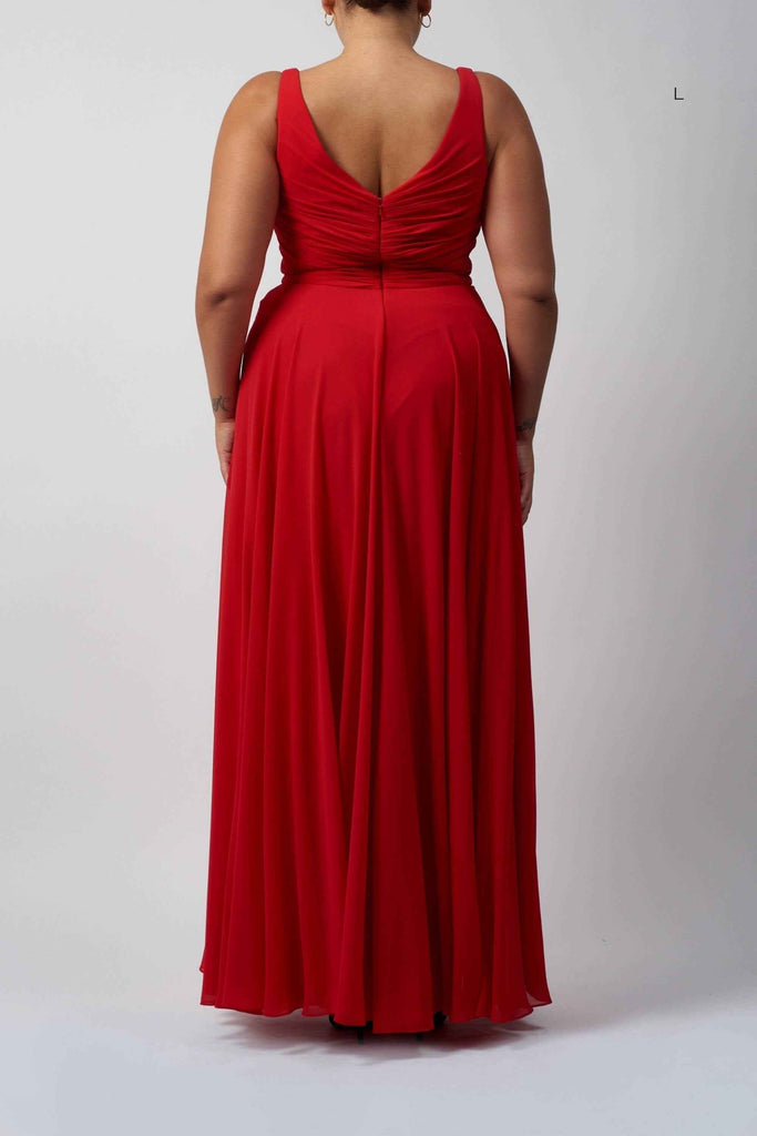 Back view of red chiffon knot front dress in plus size, showcasing ruched detailing and flowing full-length skirt.