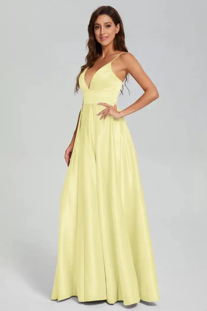 Ava Light Yellow Satin Ballgown with Pockets by Jessica Stuart featuring a deep V-neckline, open back, and full satin skirt. Ideal for prom or evening wear.