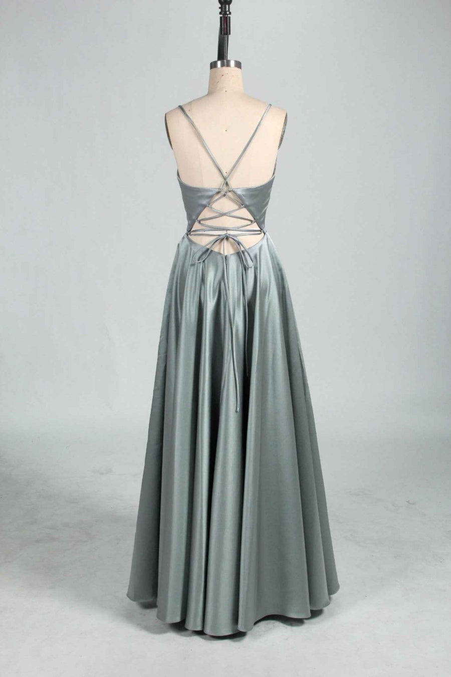 Ava Light Yellow Satin Ballgown with Pockets by Jessica Stuart shown from the back, featuring a lace-up open back and full satin skirt for prom or evening wear.