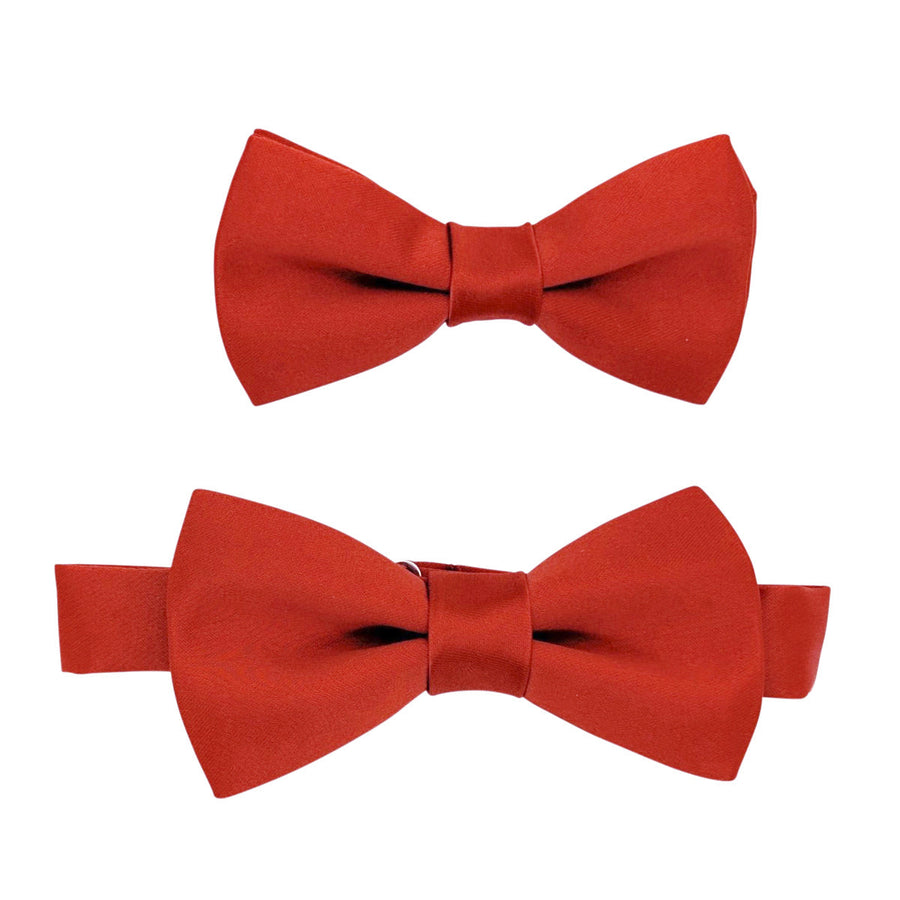 Two sizes of Sienna Boys Bow Ties in rust-red, pre-tied and adjustable for children. Perfect accessory for weddings and special occasions.