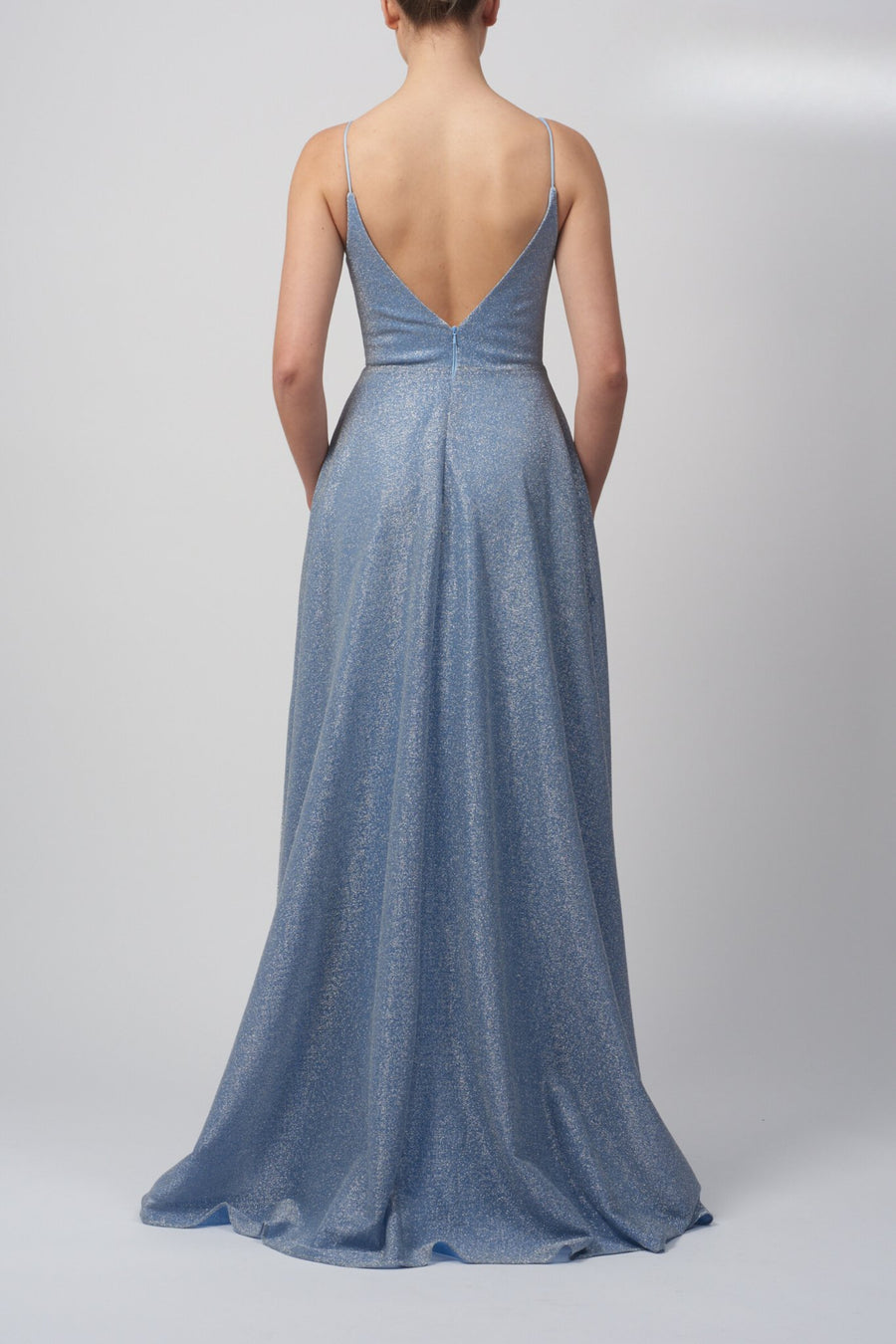 Back view of Pleated Glitter Dress MC28316 in powder blue with V-back, zip closure, and flowing pleated skirt. Ideal for prom or formal events.