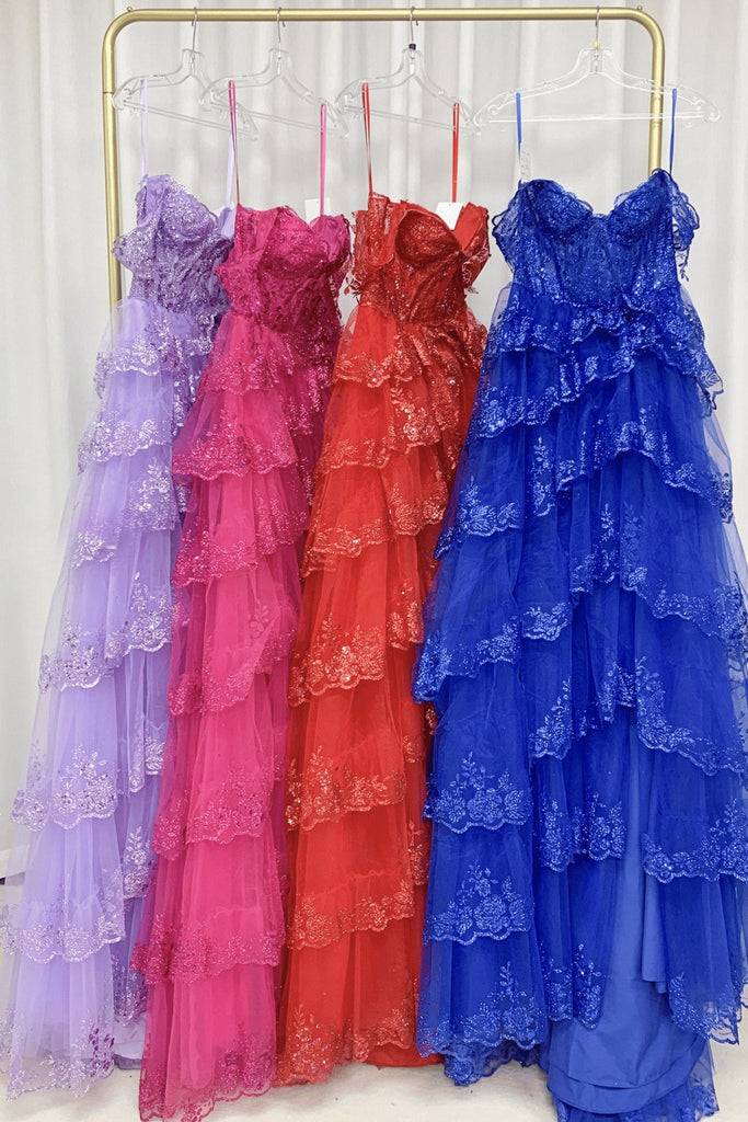 rail of 4 prom dresses, lilac, lavender, red and blue
