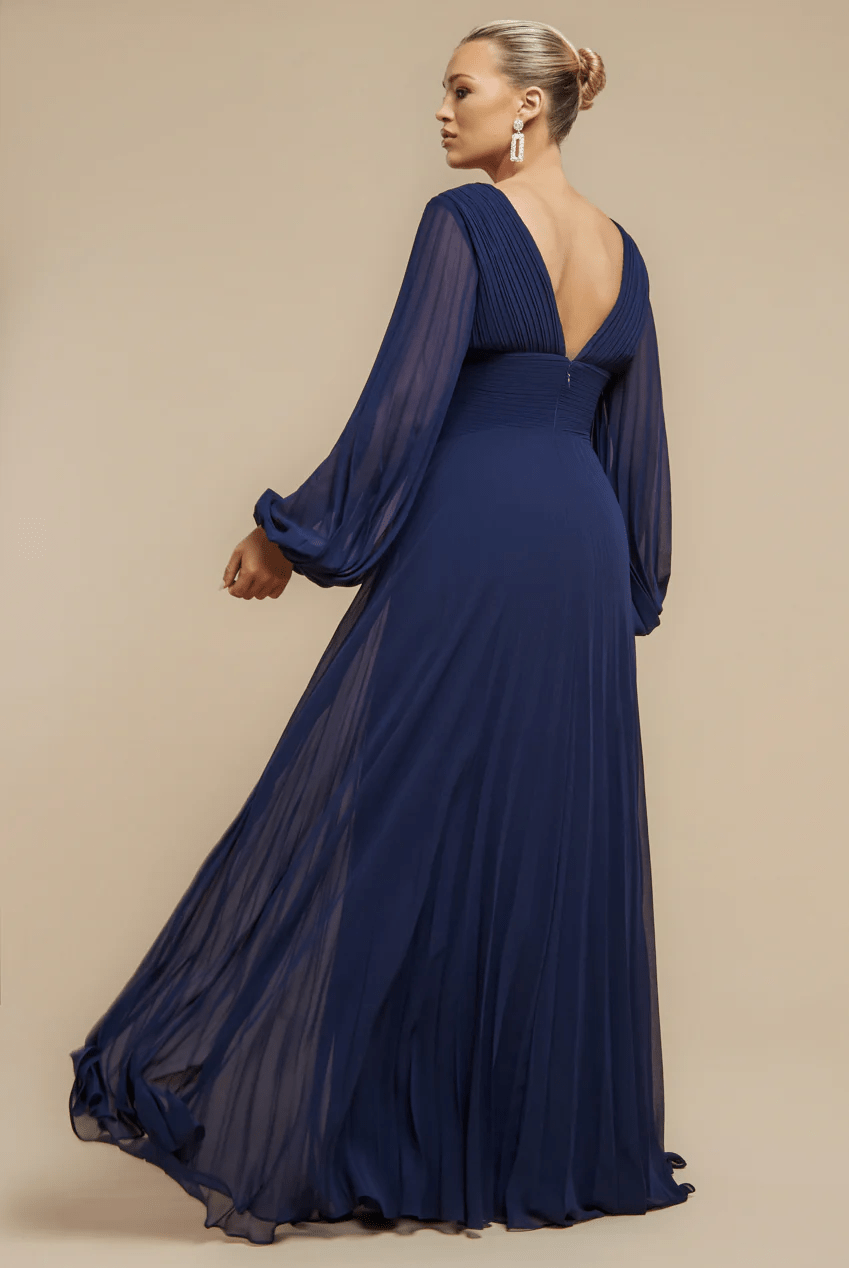 Goddiva Chiffon Maxi Dress in Navy - Bridesmaids & Evening Events shown in navy blue with pleated balloon sleeves and deep V-back. Elegant flowy gown ideal for weddings and formal occasions.