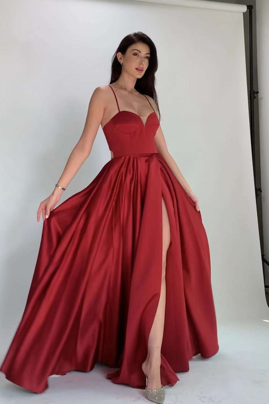 Imogen Dress in wine satin with mesh bust detail, thigh-high slit, and flowing skirt, ideal for prom or formal events.