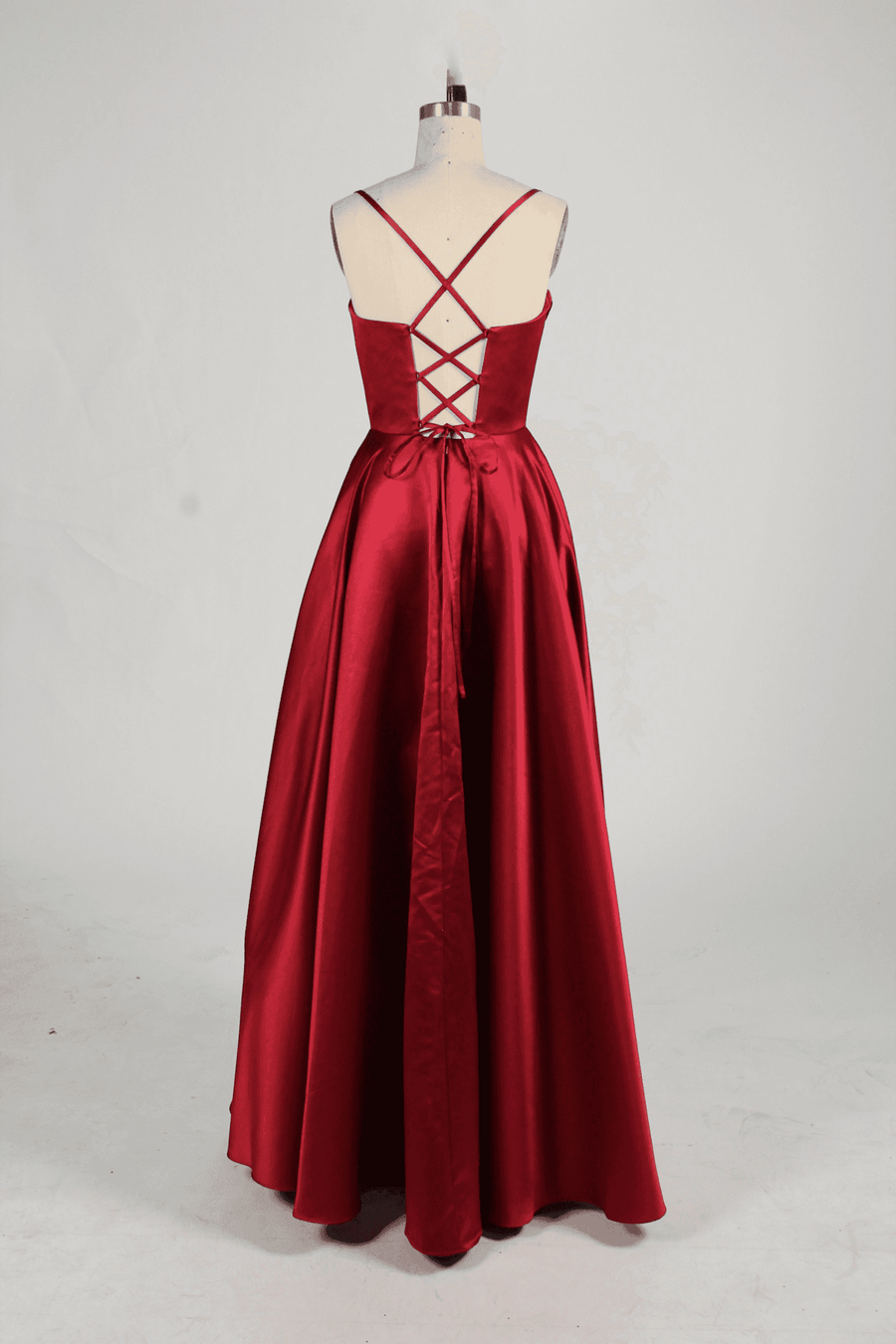 Keira Wine Satin Ballgown with lace-up back and flowing skirt, perfect for prom or evening events. Features elegant satin fabric and floor-length design.