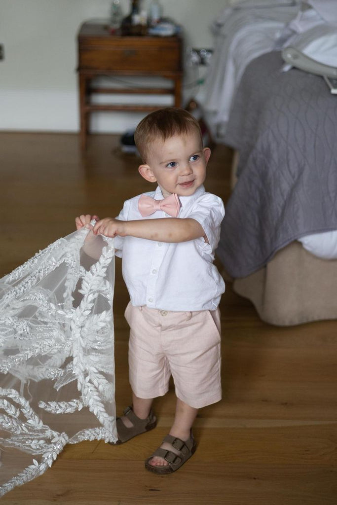 Toddler wearing Vintage Rose Boys Bow Tie with matching shorts and white shirt, ideal for weddings and special occasions in childrenswear fashion.
