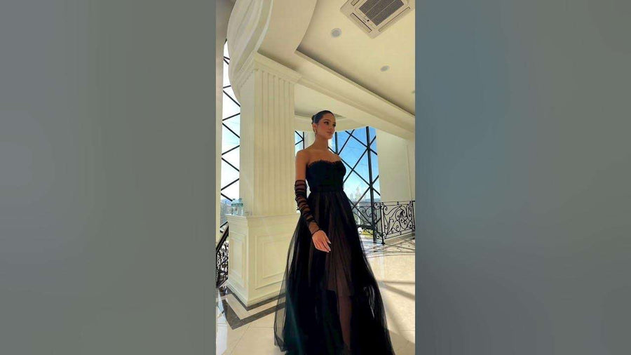 Nicoletta NC1064 Steel Grey Strapless Tulle Gown with sheer corset bodice and full A-line overlay, styled with mesh gloves in a luxury setting.