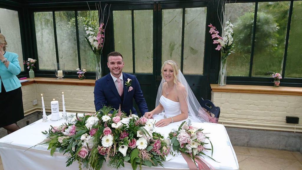 Groom at signing table wearing Rose Gold Pocket Square - Wedding Accessory | Handmade, Durable. Matches floral decor and bride’s bouquet beautifully.
