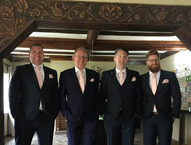 Men in navy suits styled with Vintage Rose Pocket Square - Handkerchief Polyester | Dry Clean, adding a soft pink accent for formal events.