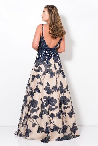 back view of model in navy and cream ballgown