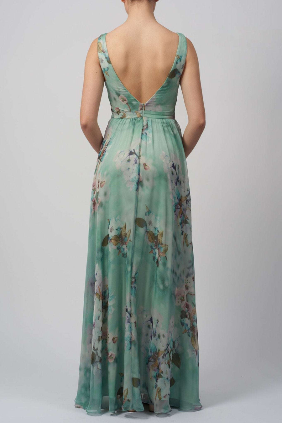 Chiffon floral printed dress in mint with low V-back and flowing skirt, ideal for summer events, proms, or bridesmaid wear. Features zip fastening and floral print.