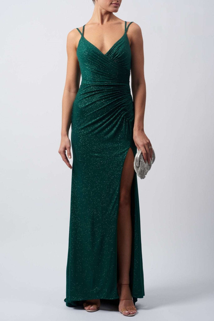 lady wearing a forest green evening dress in stretch glitter fabric with rouching