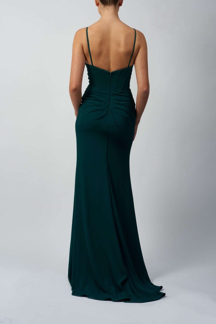 Mascara Prom Dress MC16326 in forest green satin with a fitted silhouette and spaghetti straps, shown from the back to highlight ruched detailing.