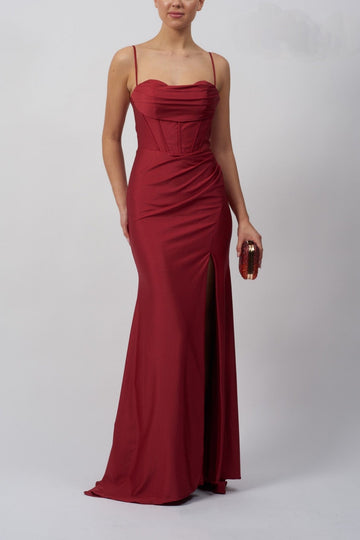 lady wearing a wine corset top evening dress with high slit