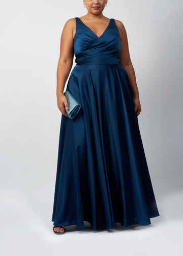 curvy lady wearing a blue satin prom dress