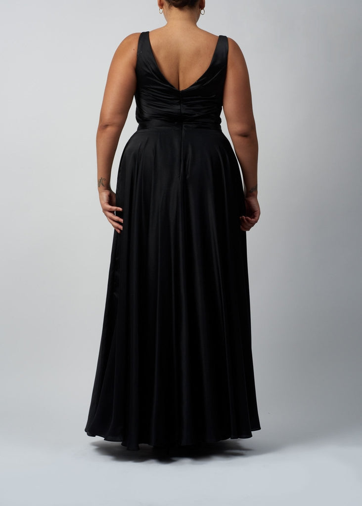 back view of curvy lady wearing black wrap top satin ballgown