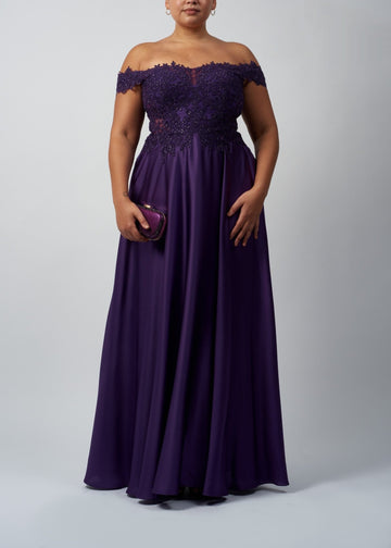plus size lady wearing lace and satin evening dress in dark purple