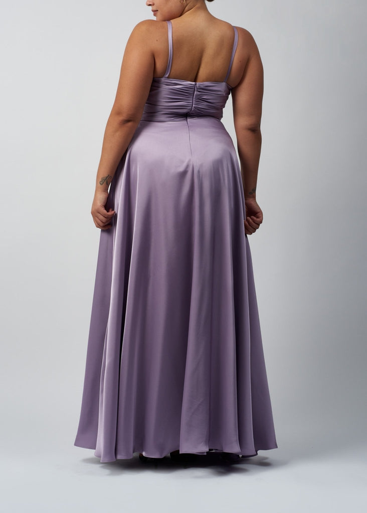 curvy lady wearing a lavender satin dress with rouched zip up back