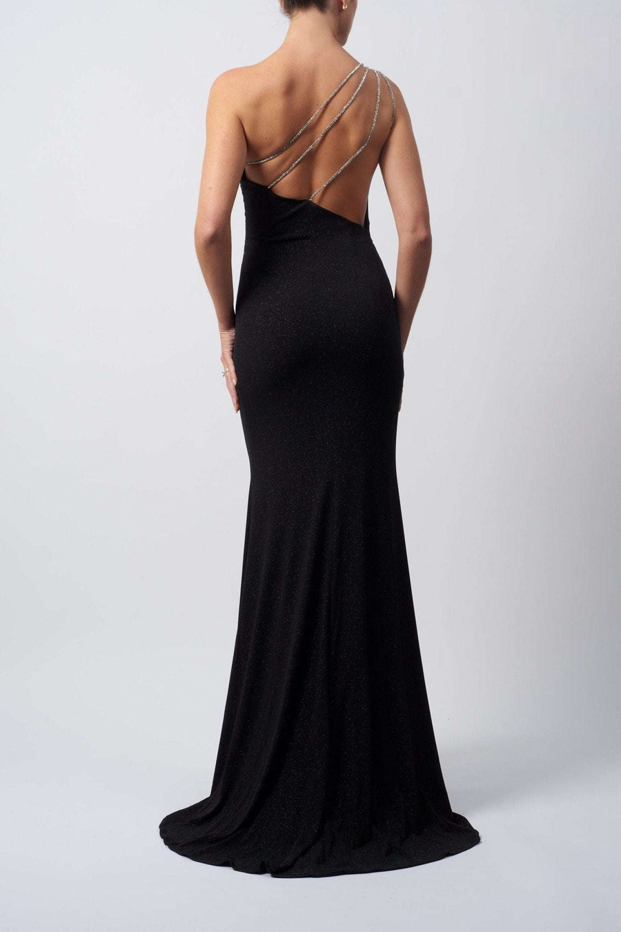 Back view of the black one-shoulder diamond strap jersey dress by Mascara London, showing the diamond straps and rouched detailing on the back
