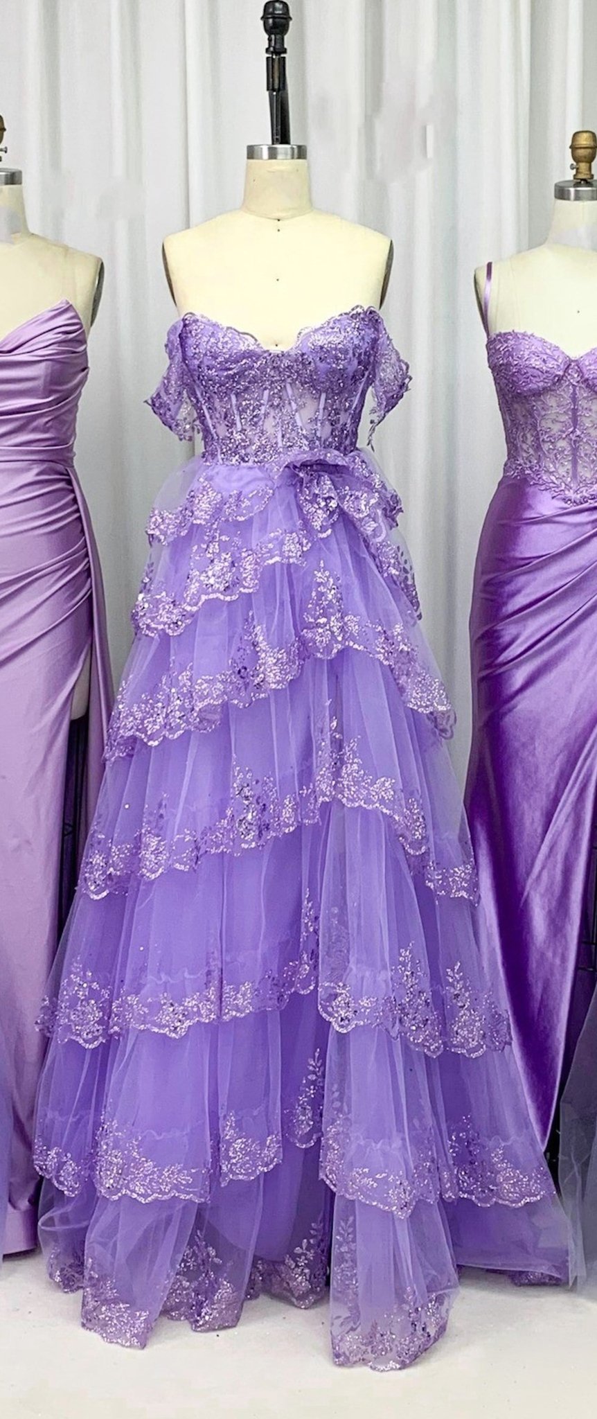 Chloe Lilac Glitter Dress - Off-Shoulder Prom gown with lace appliques, sequin embellishments, and tiered glitter tulle skirt on display mannequin.