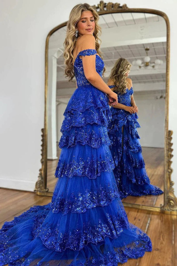 blond girl in tired royal blue prom dress