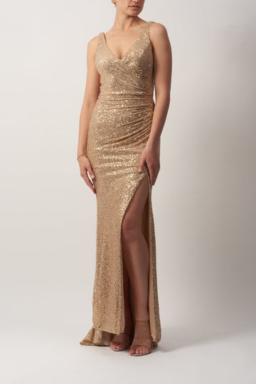 model standing in Gold Sequin Wrap dress 