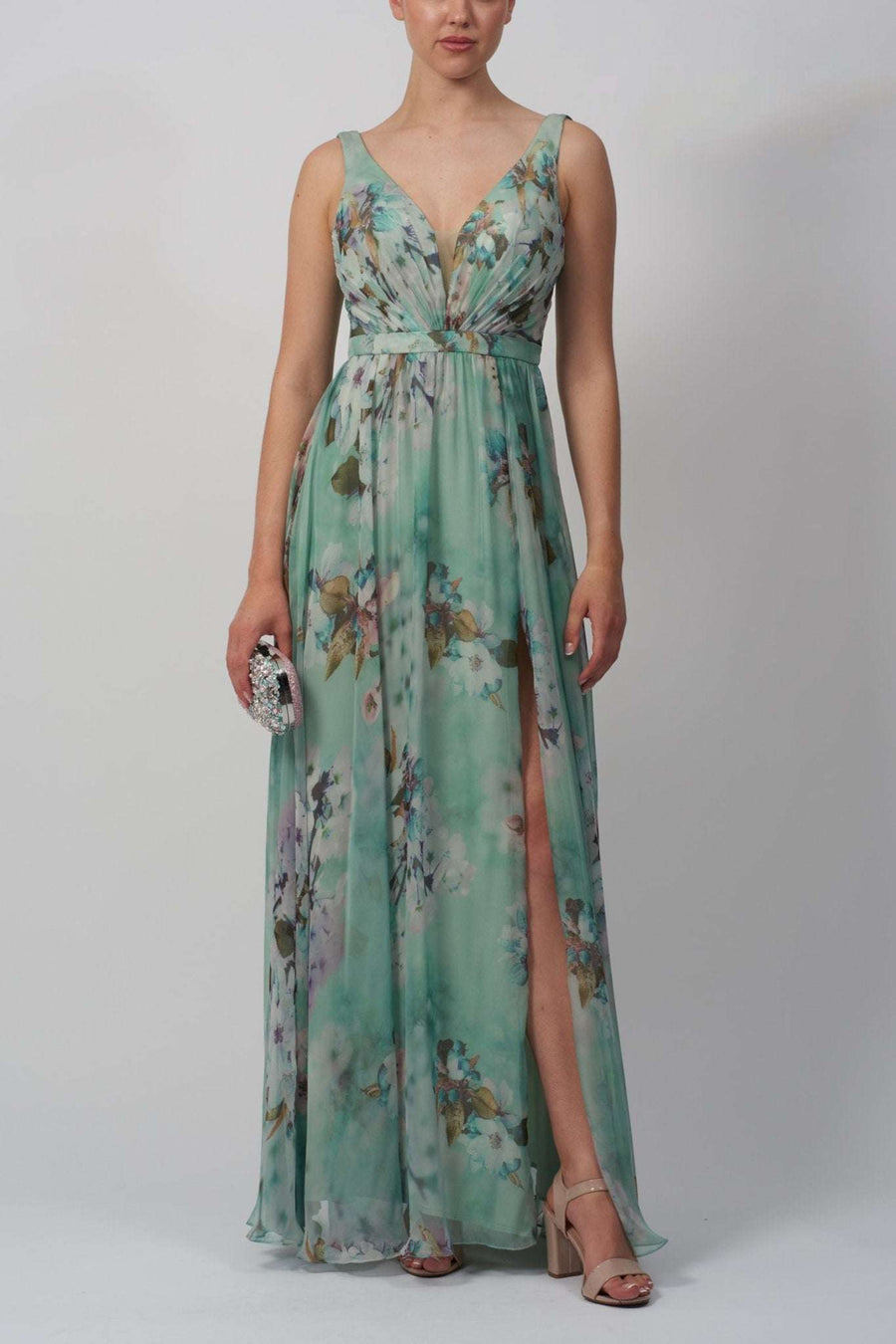 Chiffon floral printed dress in mint with V-neckline, mesh insert, and low V-back, featuring a leg split and flowing silhouette for summer events.